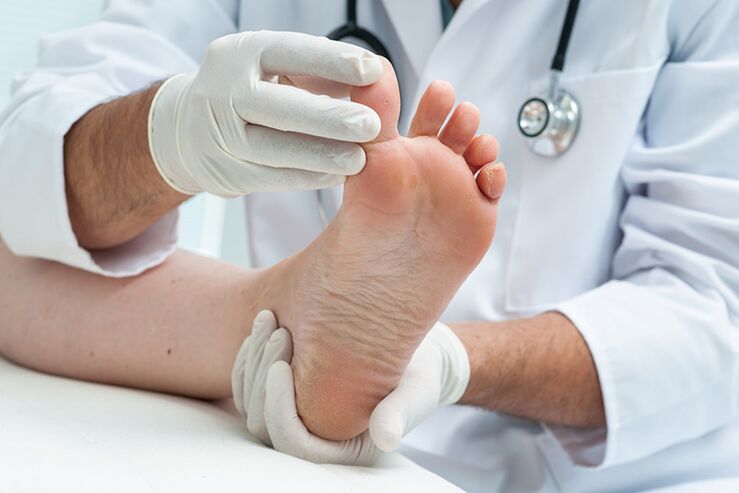 The dermatologist checks the patient's legs